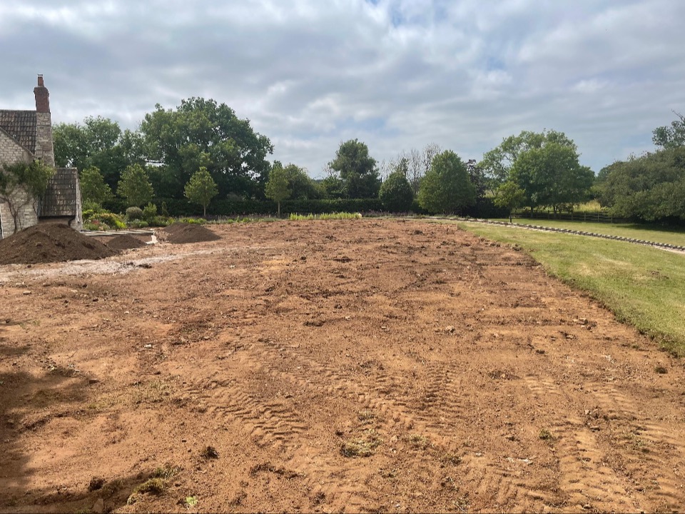 The bare, levelled plot beside the house before the garden was built